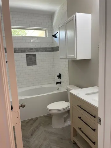 a bathroom with a sink a toilet and bathtub
