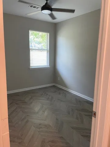 a view of room with window and a ceiling fan
