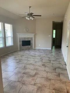 a view of a livingroom with a fireplace and window