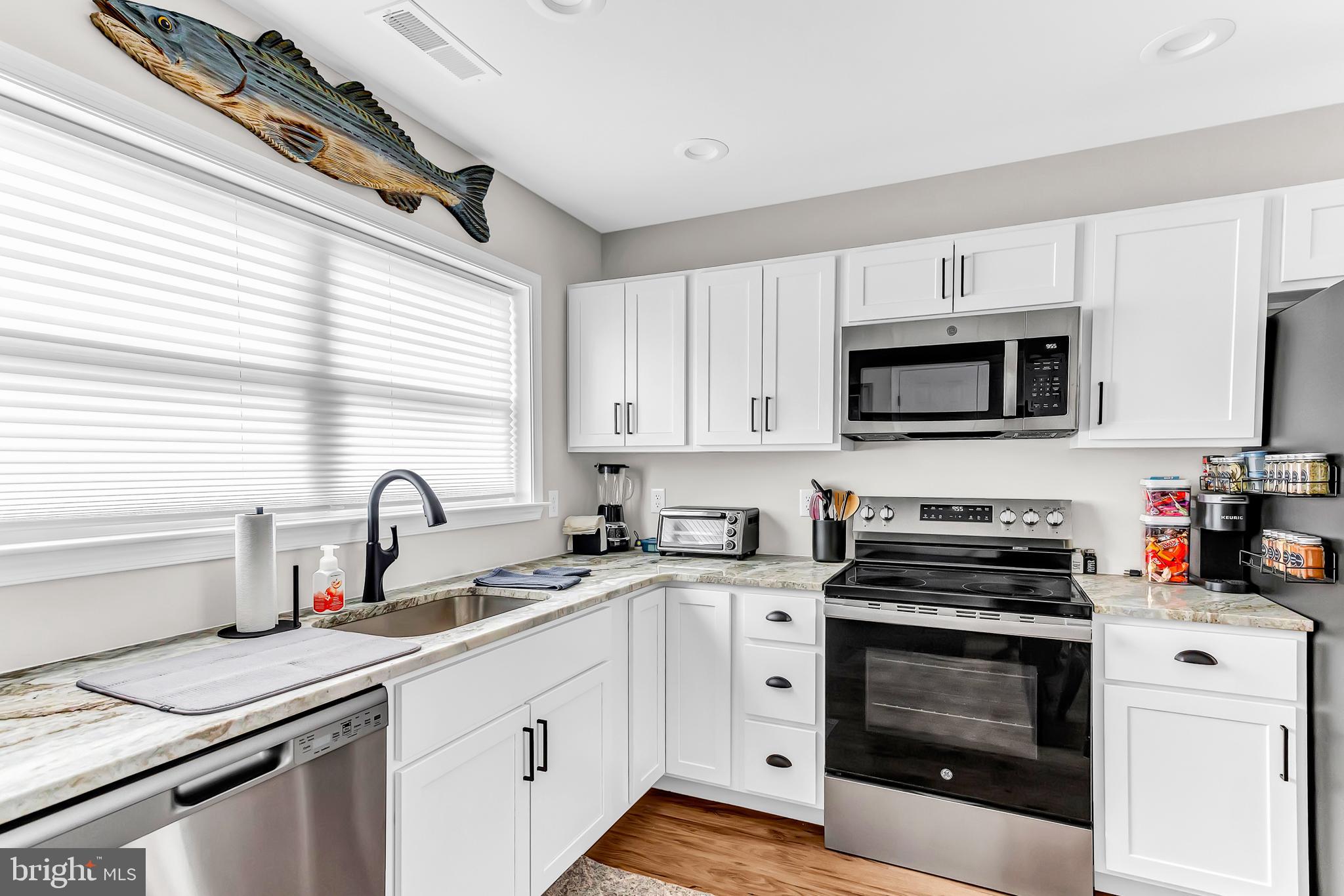 25640 Frenchtown Road Westover, MD 21871 - Photo 5 of 39 Modern kitchen with sleek white cabinetry.