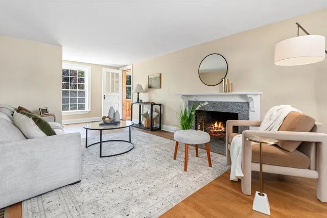 a living room with furniture a rug and a fireplace