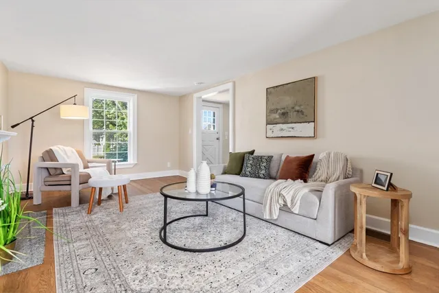 a living room with furniture a large window and gym equipment