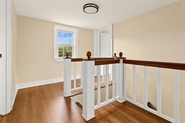 a view of a room with wooden floor and chair