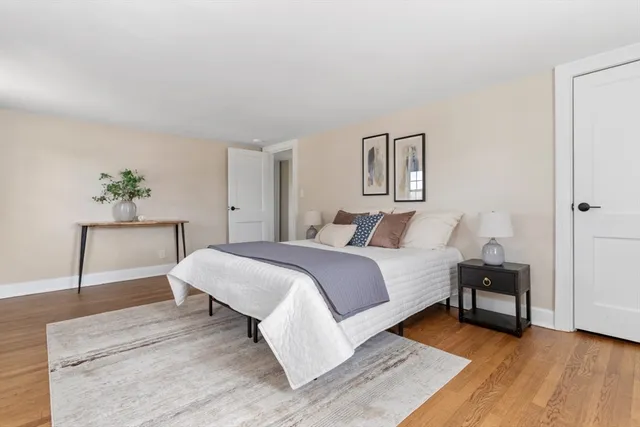 a bedroom with a bed and a painting on the wall