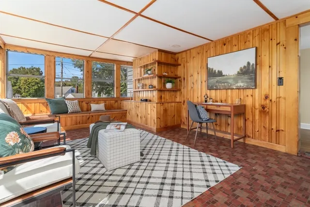 a living room with furniture and a floor to ceiling window