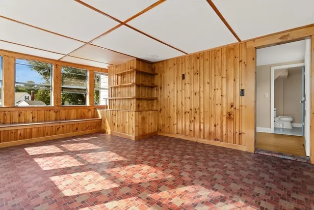 a front view of a house with yard and tree s