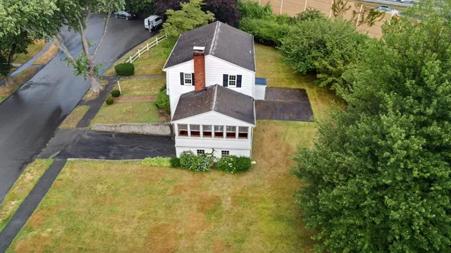 an aerial view of a house with a garden and swimming pool