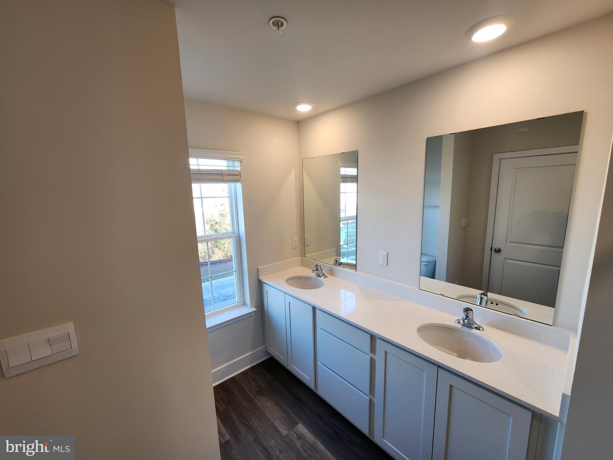 213 Joppa Farm Road Joppa, MD 21085 - Photo 20 of 22 a bathroom with a double vanity sink and a mirror
