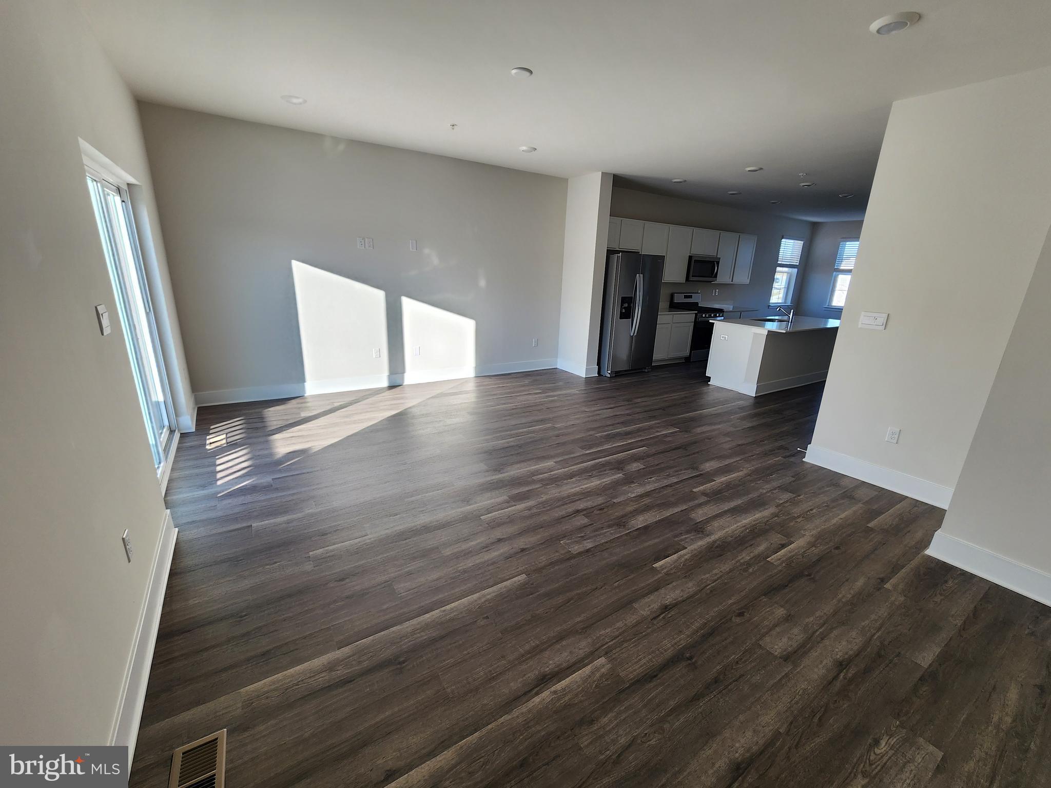 213 Joppa Farm Road Joppa, MD 21085 - Photo 7 of 22 a view of a big room with wooden floor and a window