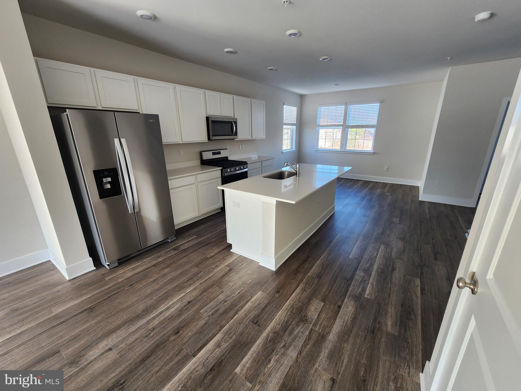 213 Joppa Farm Road Joppa, MD 21085 - Photo 9 of 22 a kitchen with refrigerator a microwave a sink and wooden floor