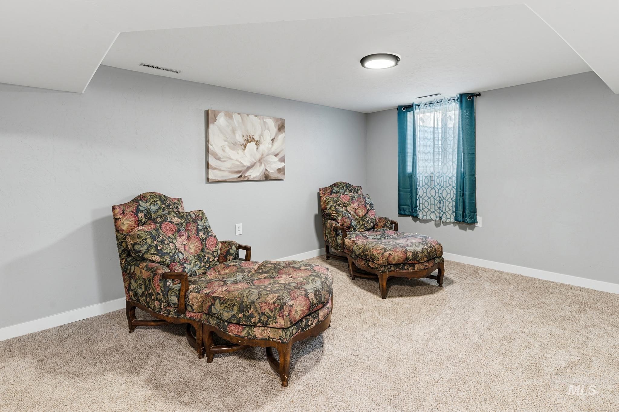 619 Thain Road Lewiston, ID 83501 - Photo 28 of 44 Carpeted interior space featuring light grey walls, white trim, and a ceiling-mounted light fixture