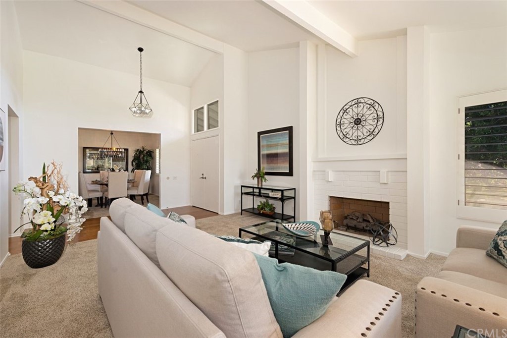 11 Jetty Drive Corona del Mar, CA 92625 - Photo 2 of 44 a living room with furniture a clock and a fireplace