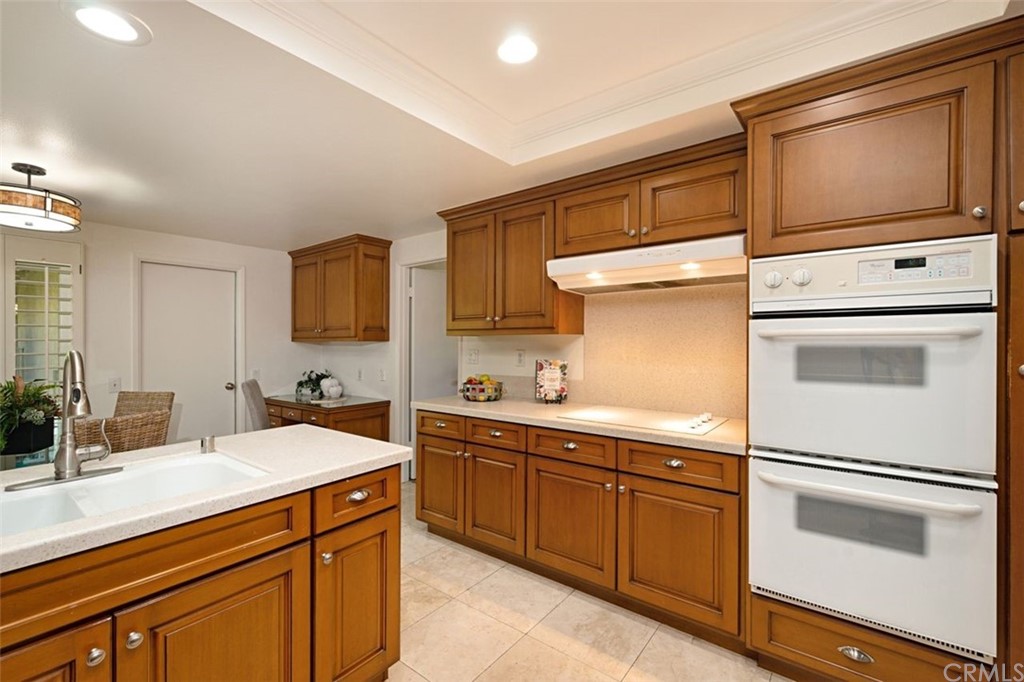 11 Jetty Drive Corona del Mar, CA 92625 - Photo 11 of 44 a kitchen with a sink cabinets and microwave