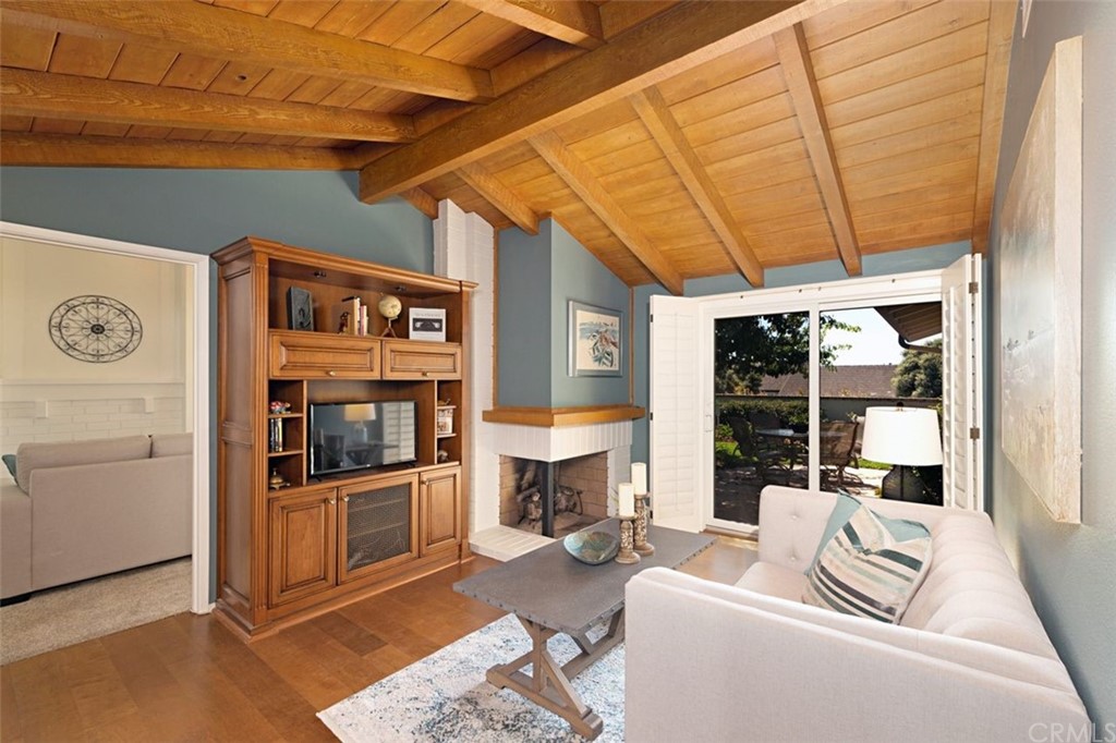 11 Jetty Drive Corona del Mar, CA 92625 - Photo 17 of 44 a living room with furniture a fireplace and next to a window