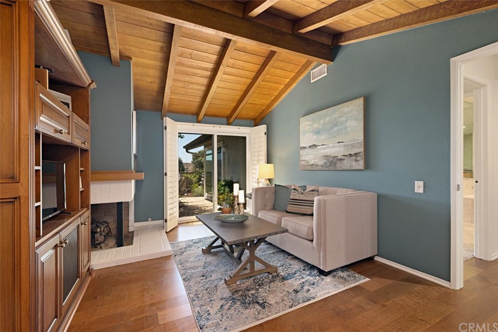 11 Jetty Drive Corona del Mar, CA 92625 - Photo 18 of 44 a living room with furniture a flat screen tv and a table