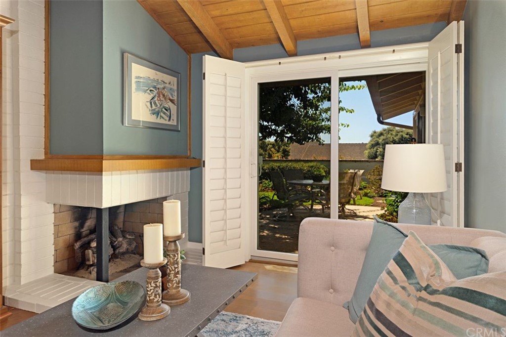 11 Jetty Drive Corona del Mar, CA 92625 - Photo 19 of 44 a living room with furniture a lamp and a fireplace
