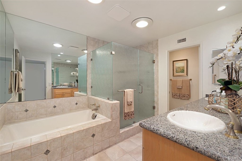 11 Jetty Drive Corona del Mar, CA 92625 - Photo 23 of 44 a bathroom with a granite countertop tub sink and mirror