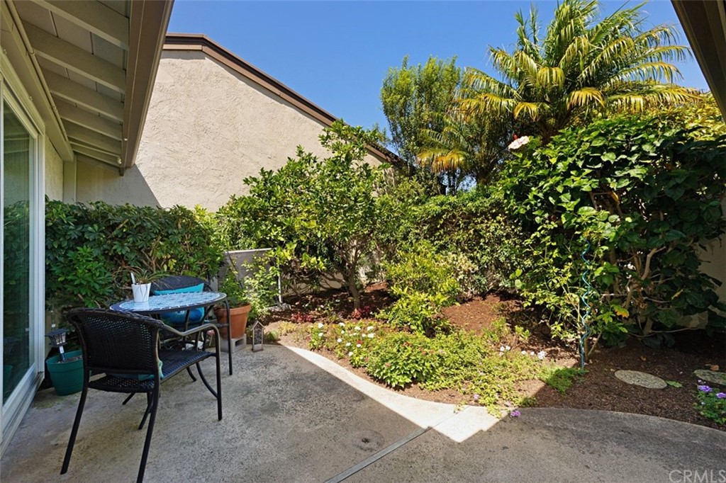 11 Jetty Drive Corona del Mar, CA 92625 - Photo 28 of 44 a backyard with a table and chairs and a potted plant