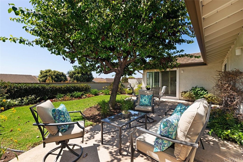 11 Jetty Drive Corona del Mar, CA 92625 - Photo 33 of 44 a view of a patio with table and chairs potted plants and a large tree