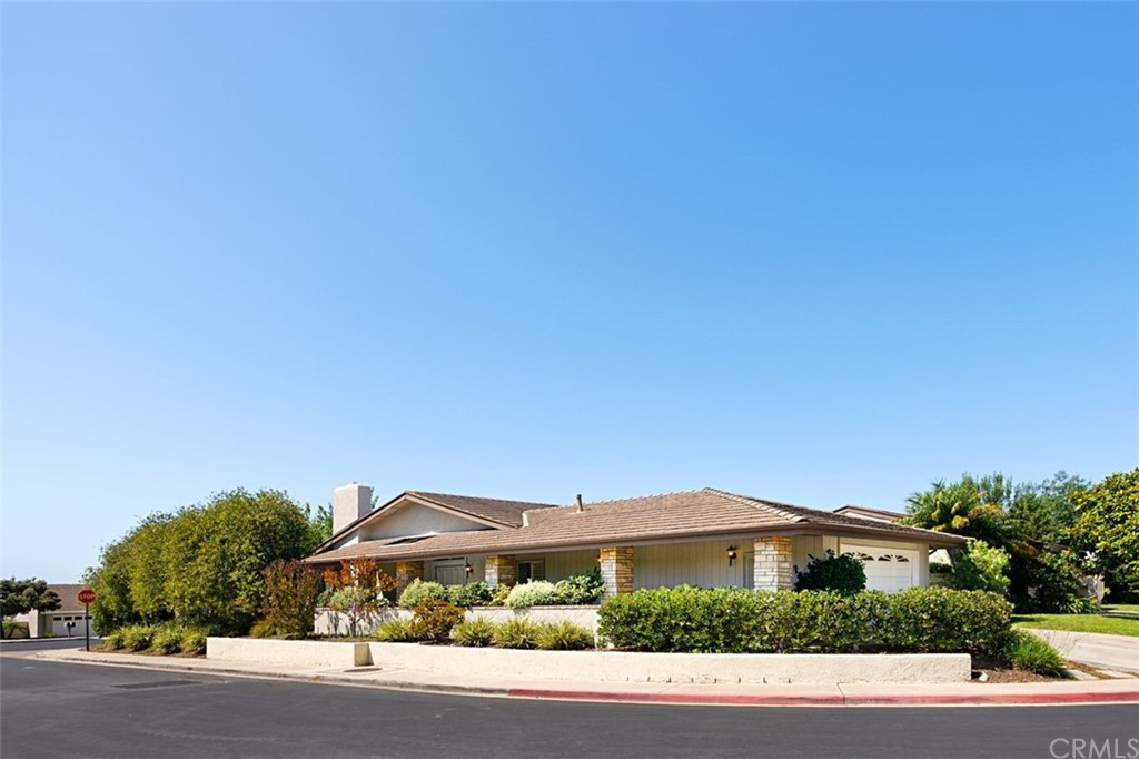 11 Jetty Drive Corona del Mar, CA 92625 - Photo 36 of 44 a front view of a house with a yard and a garage