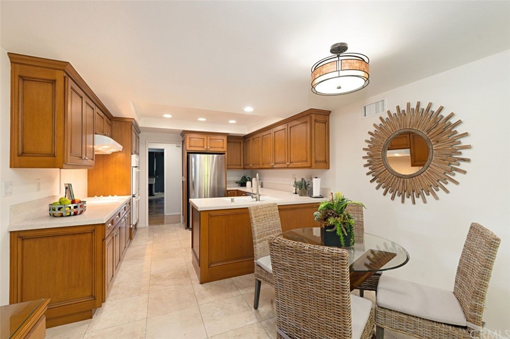 11 Jetty Drive Corona del Mar, CA 92625 - Photo 7 of 44 a kitchen with a refrigerator and a stove