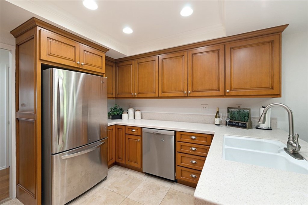 11 Jetty Drive Corona del Mar, CA 92625 - Photo 9 of 44 a kitchen with stainless steel appliances granite countertop a refrigerator and a sink