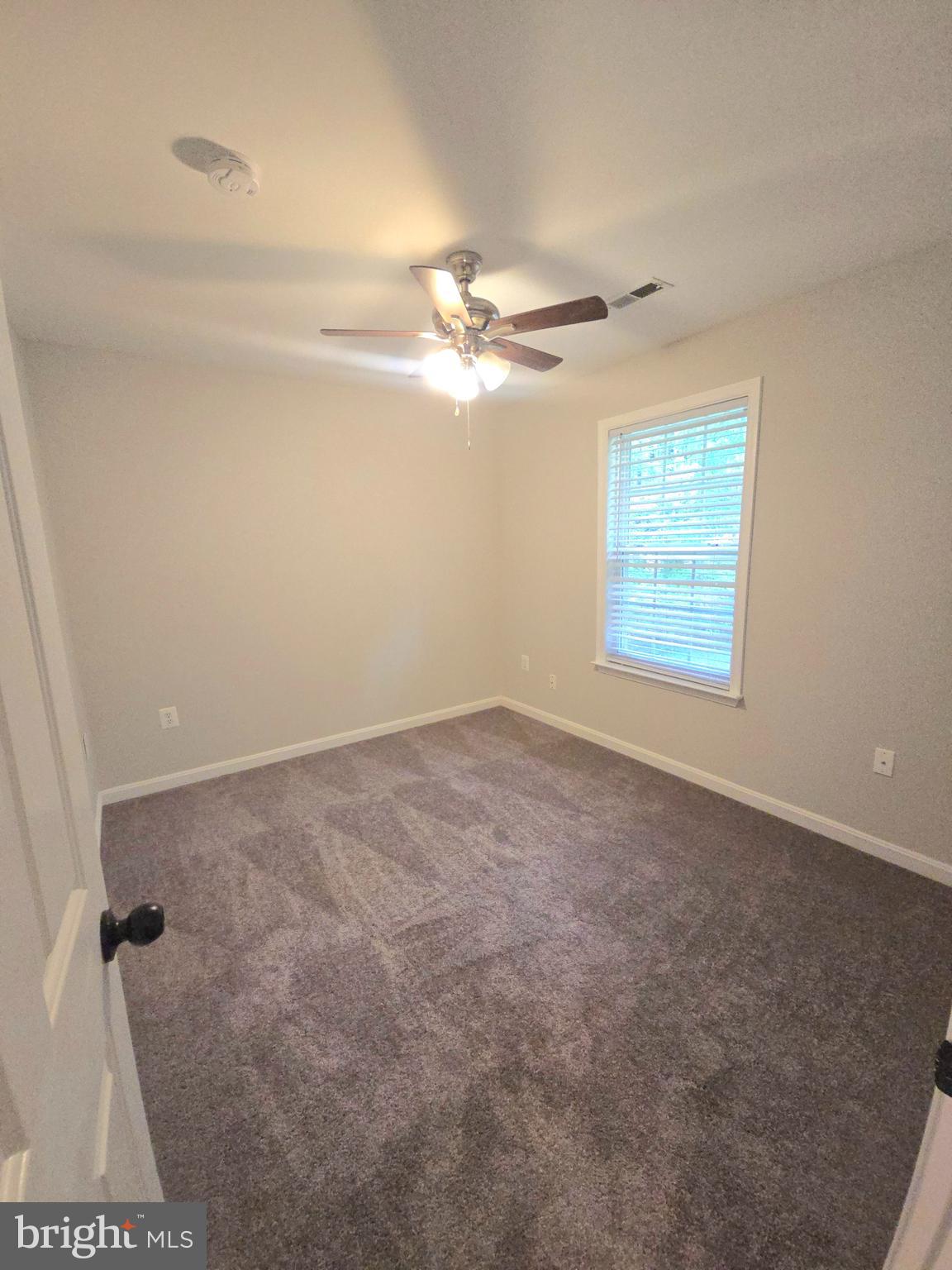 3605 Burton Road Bumpass, VA 23024 - Photo 30 of 44 an empty room with windows and fan