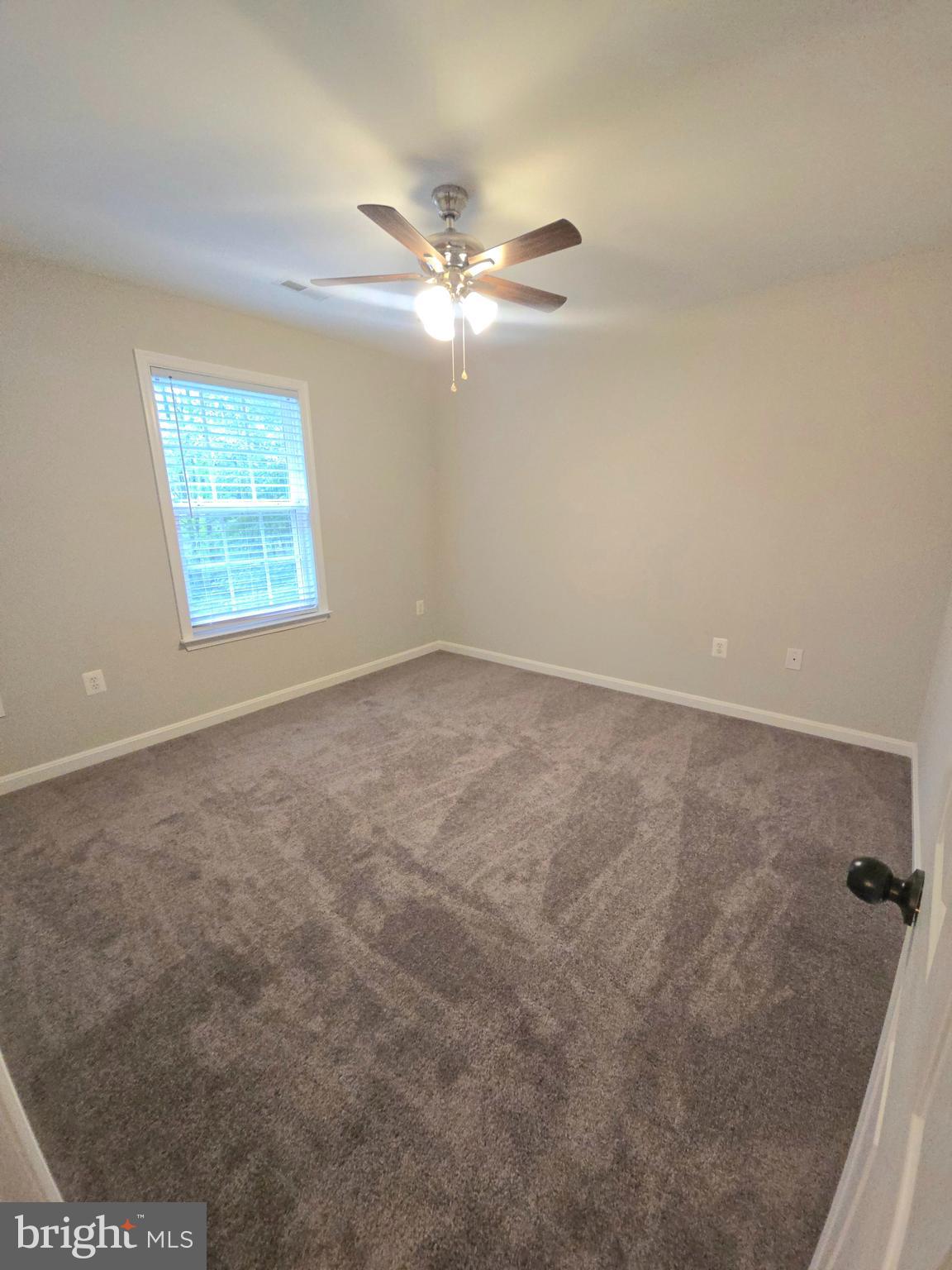 3605 Burton Road Bumpass, VA 23024 - Photo 31 of 44 an empty room with windows and fan