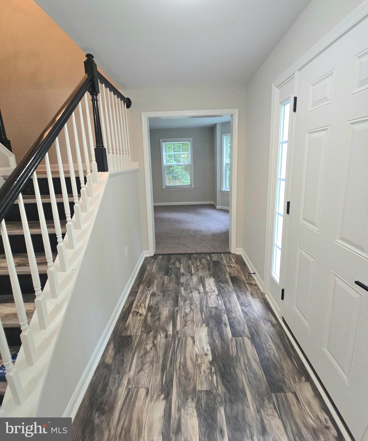 3605 Burton Road Bumpass, VA 23024 - Photo 8 of 44 a view of an empty room with wooden floor and stairs