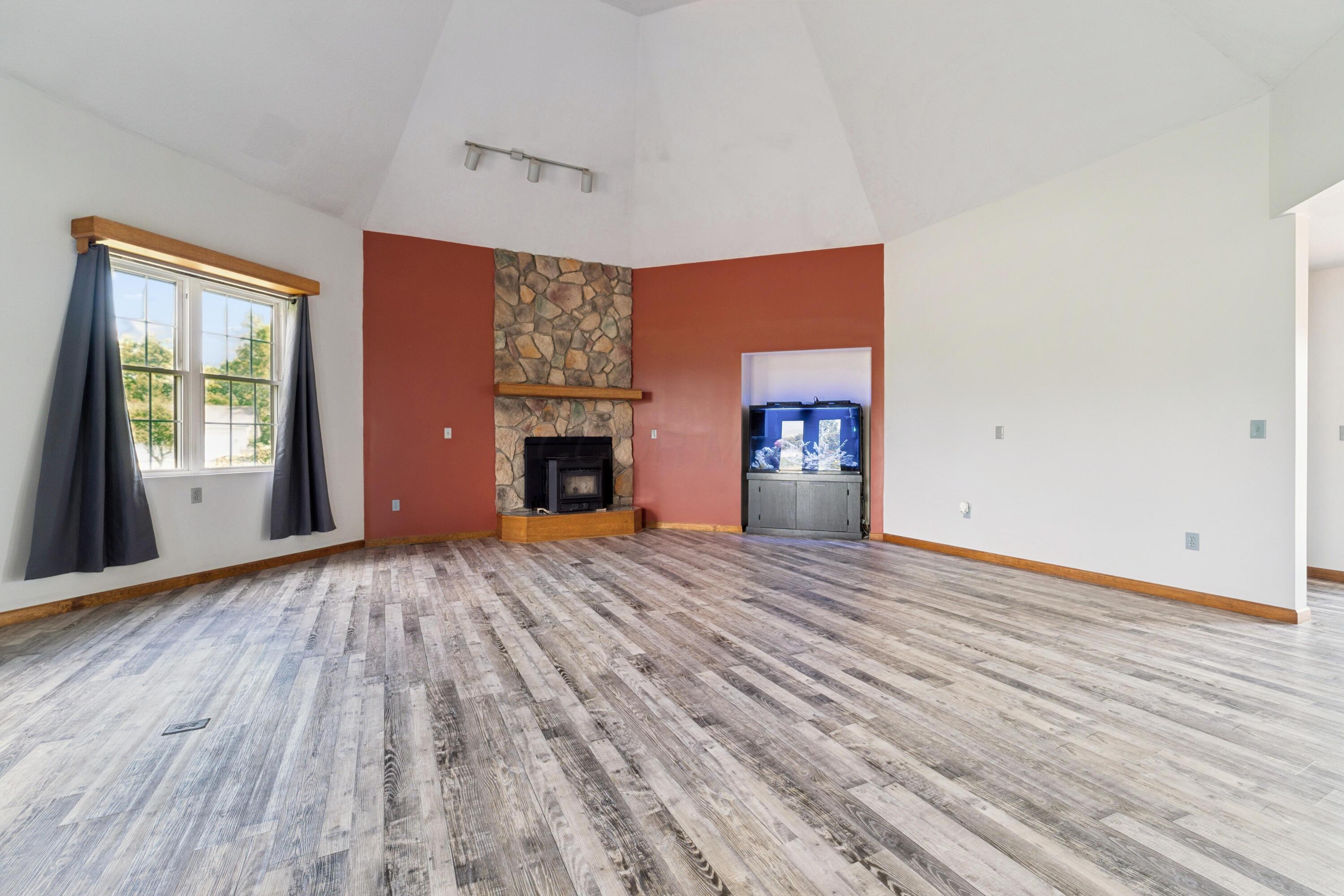 18964 London Road Circleville, OH 43113 - Photo 24 of 57 Vaulted ceiling with track lighting, wood-finish flooring.