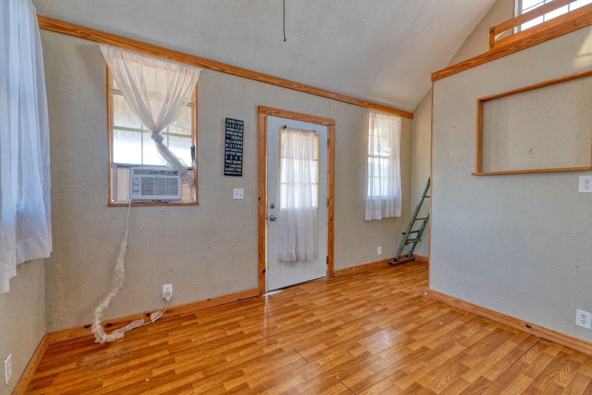 645 Old Luling Road Lockhart, TX 78644 - Photo 18 of 24 a view of an empty room with wooden floor and a window