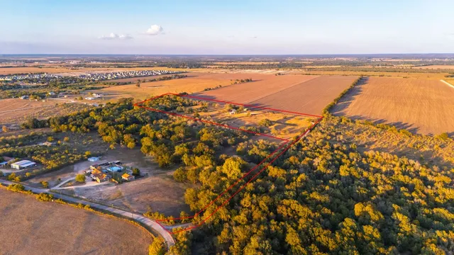 an aerial view of residential houses with outdoor space