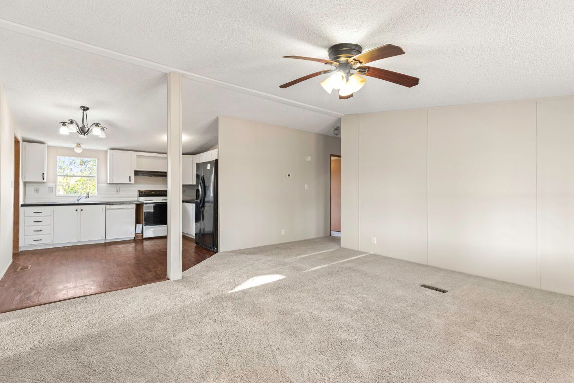 645 Old Luling Road Lockhart, TX 78644 - Photo 4 of 24 a view of a kitchen with a sink and a ceiling fan