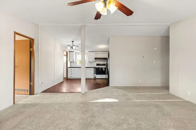 a view of a kitchen with a refrigerator and a window
