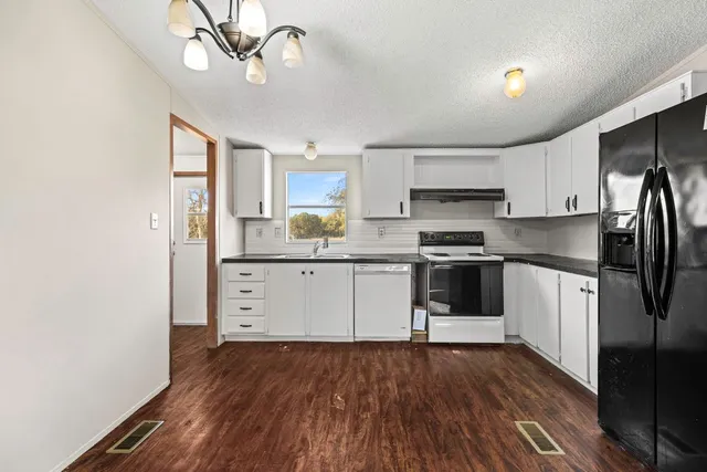 a kitchen with stainless steel appliances a refrigerator sink and microwave