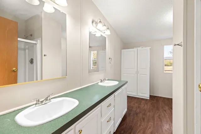 a bathroom with a sink double vanity and a mirror