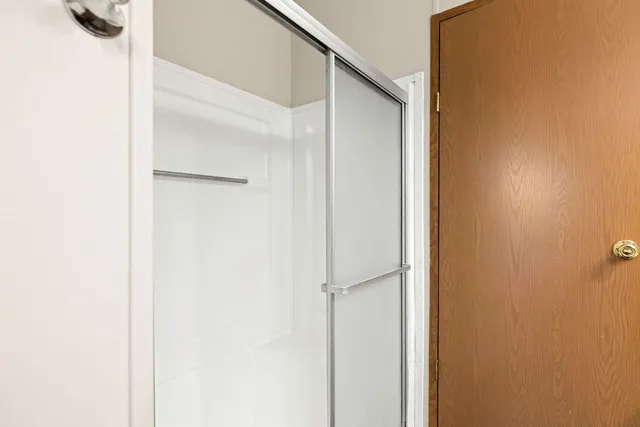 a bathroom with a glass shower door