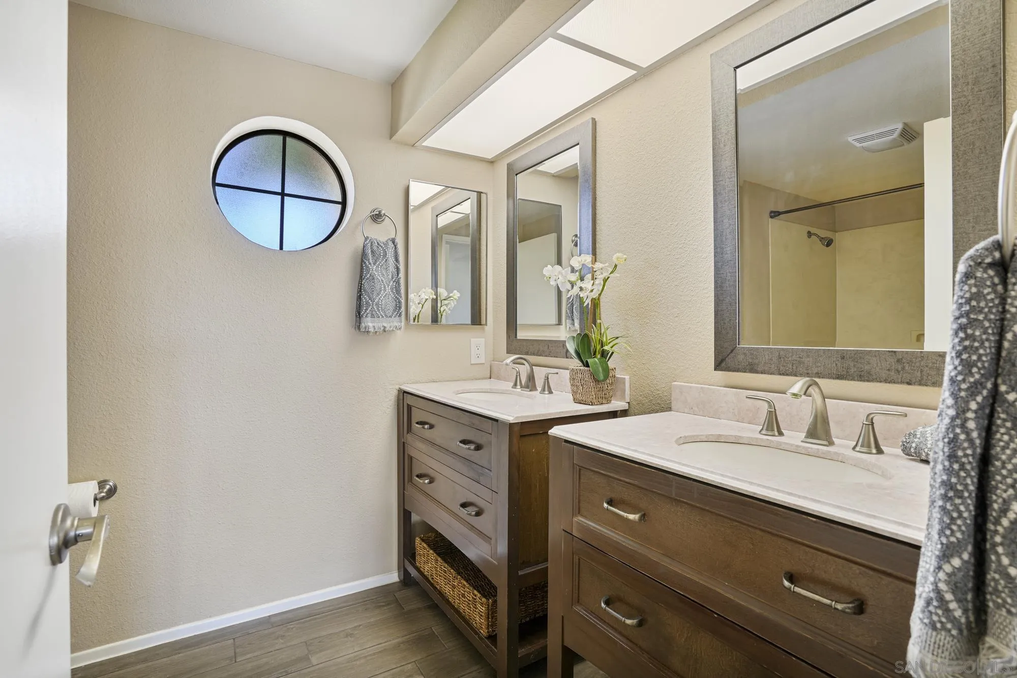 7347 Paseo Verde Carlsbad, CA 92009 - Photo 12 of 27 a bathroom with a double vanity sink and a mirror