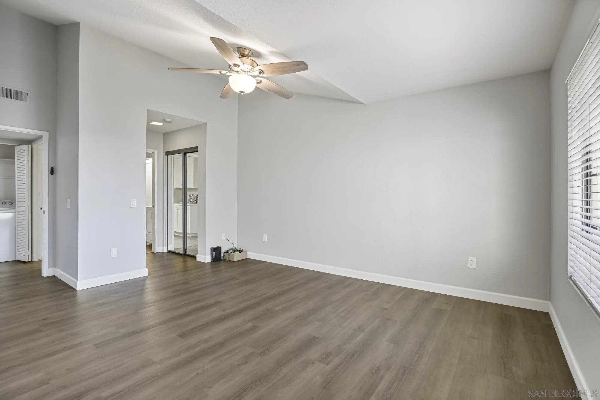 7347 Paseo Verde Carlsbad, CA 92009 - Photo 15 of 27 a view of an empty room with wooden floor and window