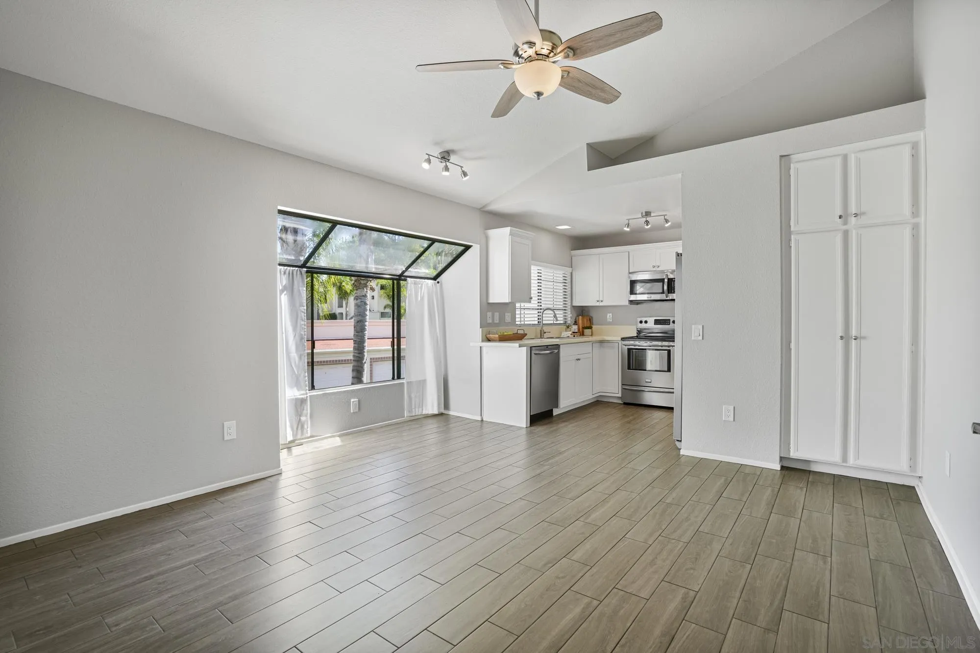 7347 Paseo Verde Carlsbad, CA 92009 - Photo 4 of 27 a view of a kitchen with wooden floor electronic appliances and window