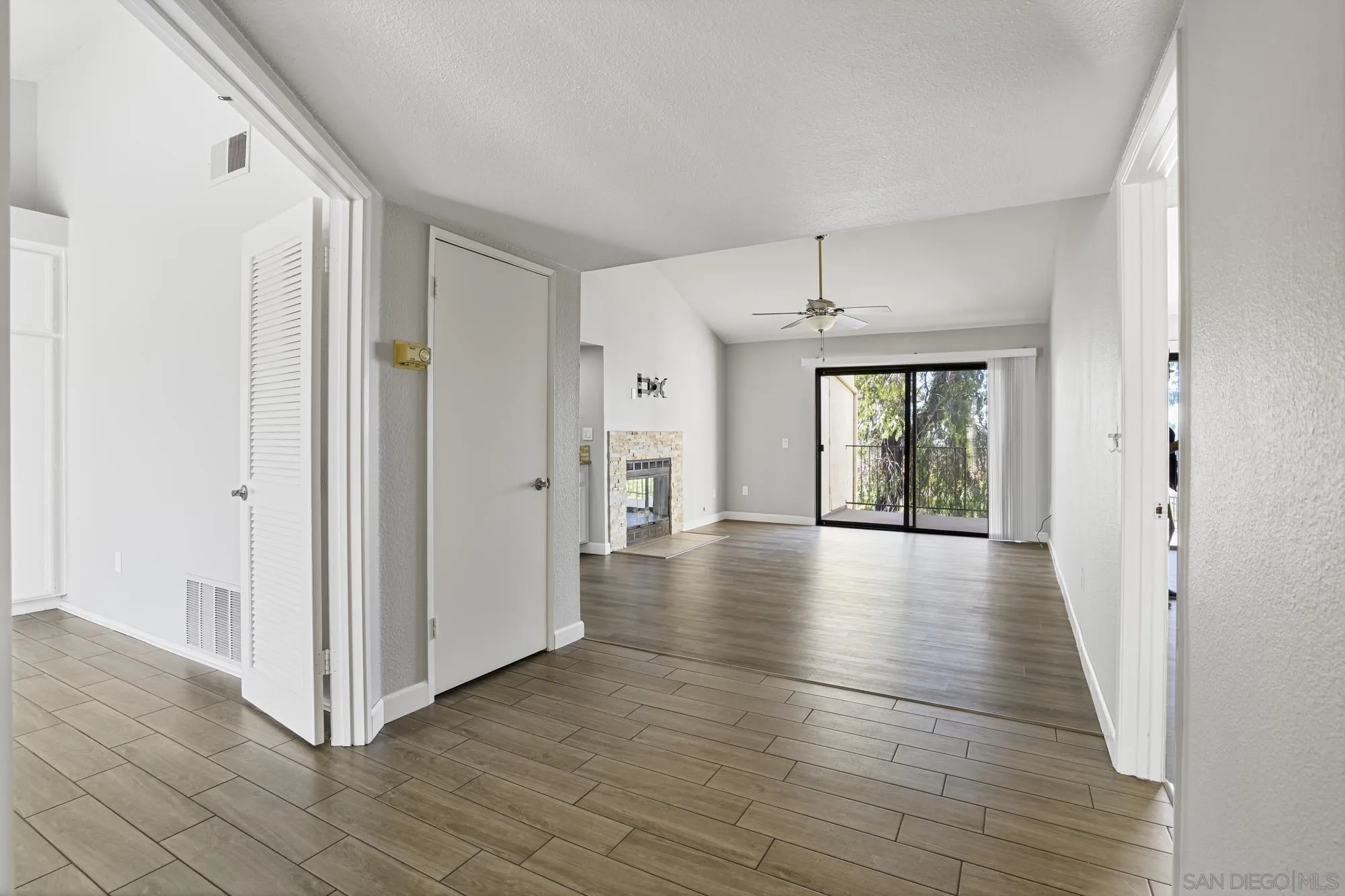 7347 Paseo Verde Carlsbad, CA 92009 - Photo 7 of 27 a view of a hallway with wooden floor and windows