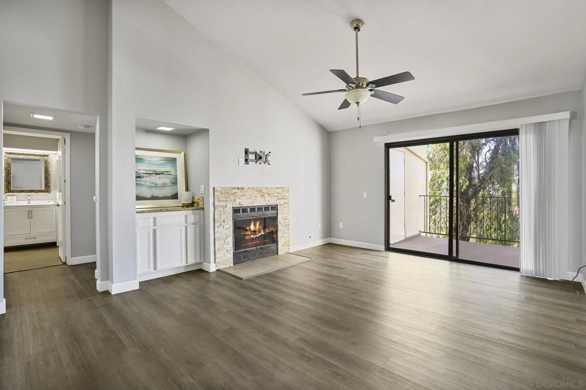 7347 Paseo Verde Carlsbad, CA 92009 - Photo 8 of 27 wooden floor fireplace and windows in an empty room