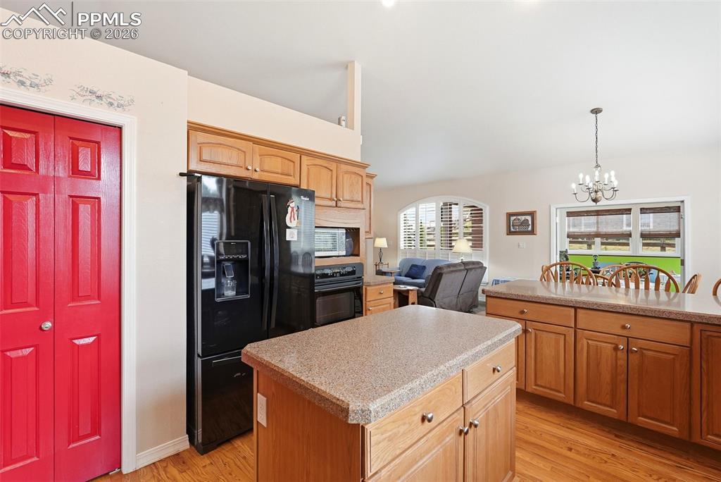 16261 Hobson Place Monument, CO 80132 - Photo 11 of 50 a kitchen with stainless steel appliances granite countertop a sink and a refrigerator