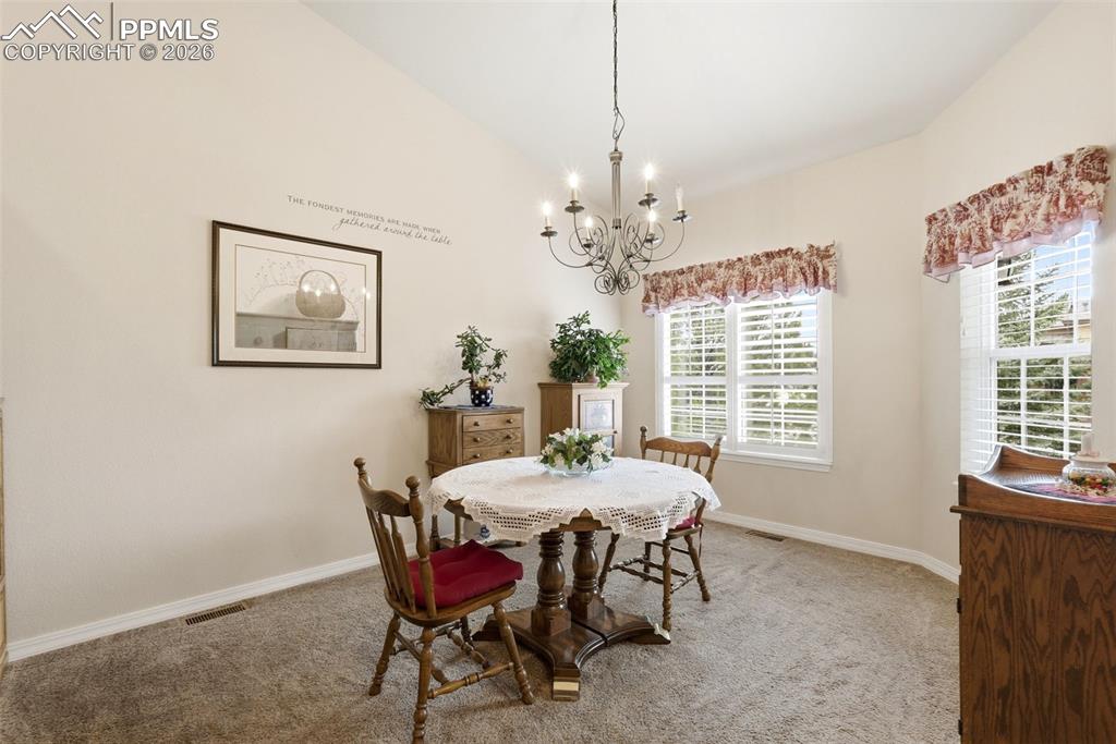 16261 Hobson Place Monument, CO 80132 - Photo 23 of 50 a dining room with furniture a chandelier and window
