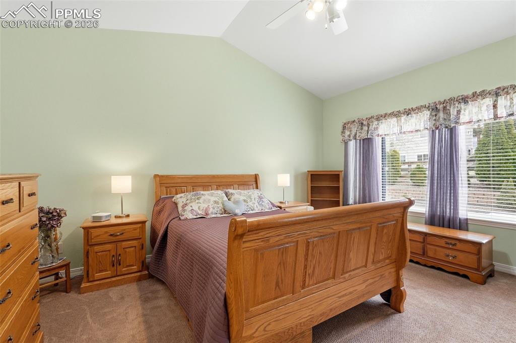 16261 Hobson Place Monument, CO 80132 - Photo 24 of 50 a bedroom with a bed and a chandelier