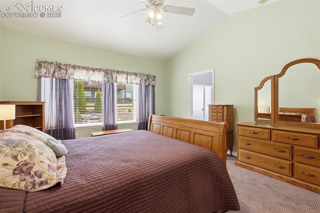 16261 Hobson Place Monument, CO 80132 - Photo 26 of 50 a bedroom with a large bed and a chandelier