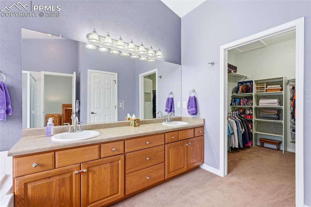 16261 Hobson Place Monument, CO 80132 - Photo 27 of 50 a spacious en suite bathroom with a granite countertop sink and a mirror