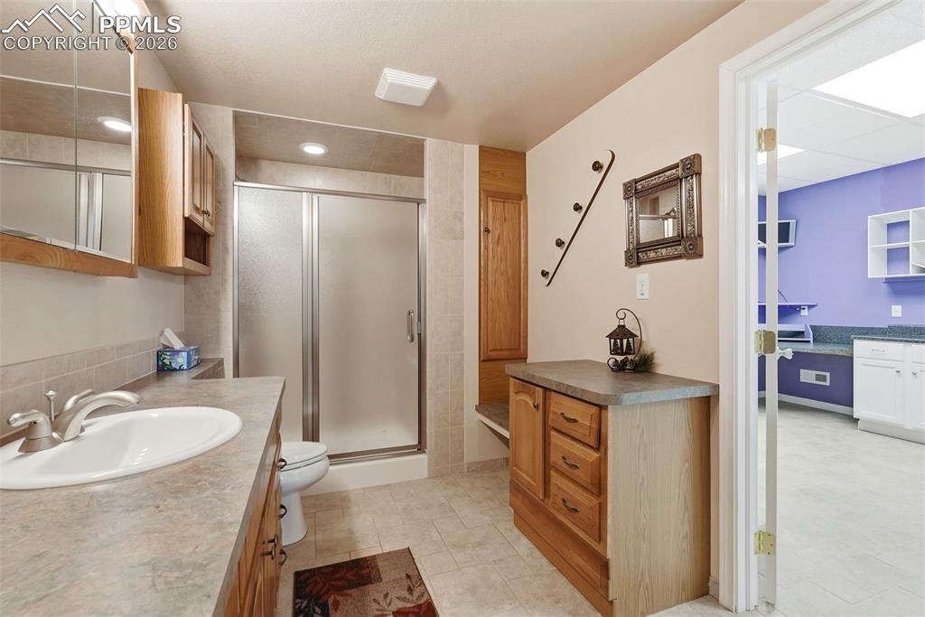 16261 Hobson Place Monument, CO 80132 - Photo 33 of 50 a spacious bathroom with a granite countertop sink mirror and
