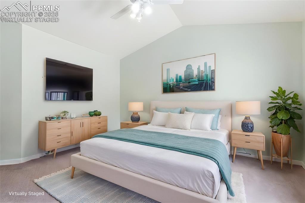 16261 Hobson Place Monument, CO 80132 - Photo 6 of 50 a bedroom with a bed and a flat screen tv