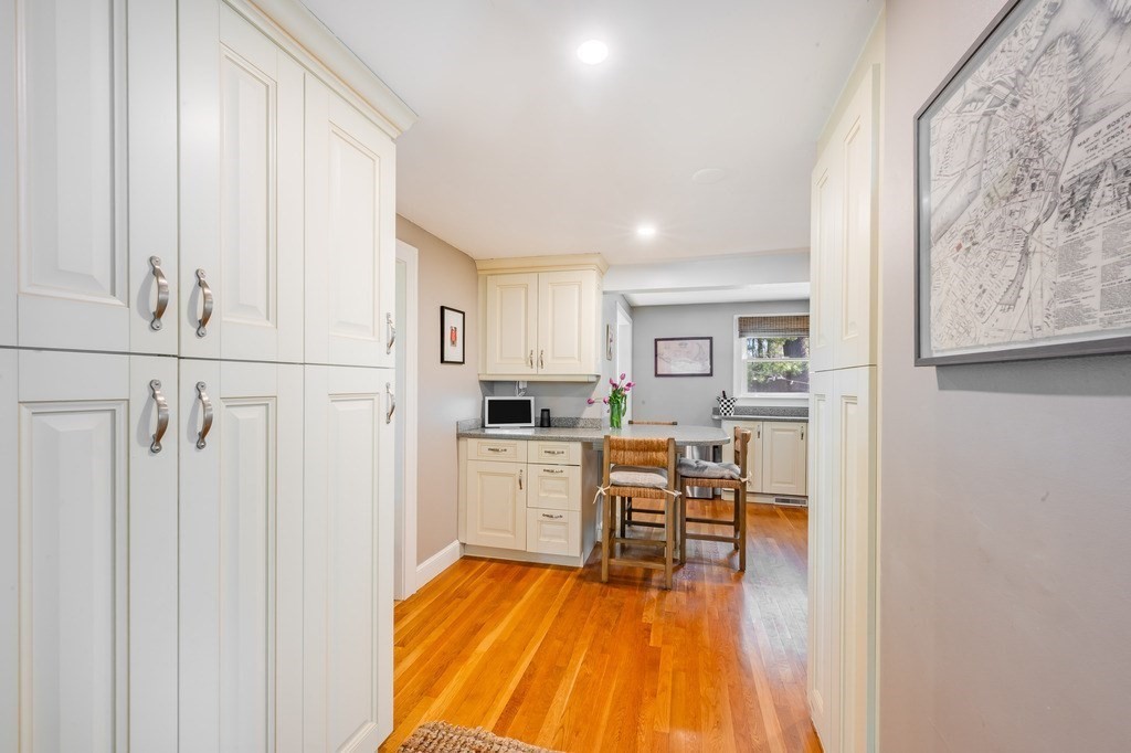 44 Pierrepont Road Newton, MA 02462 - Photo 8 of 29 a kitchen with white cabinets and wooden floor